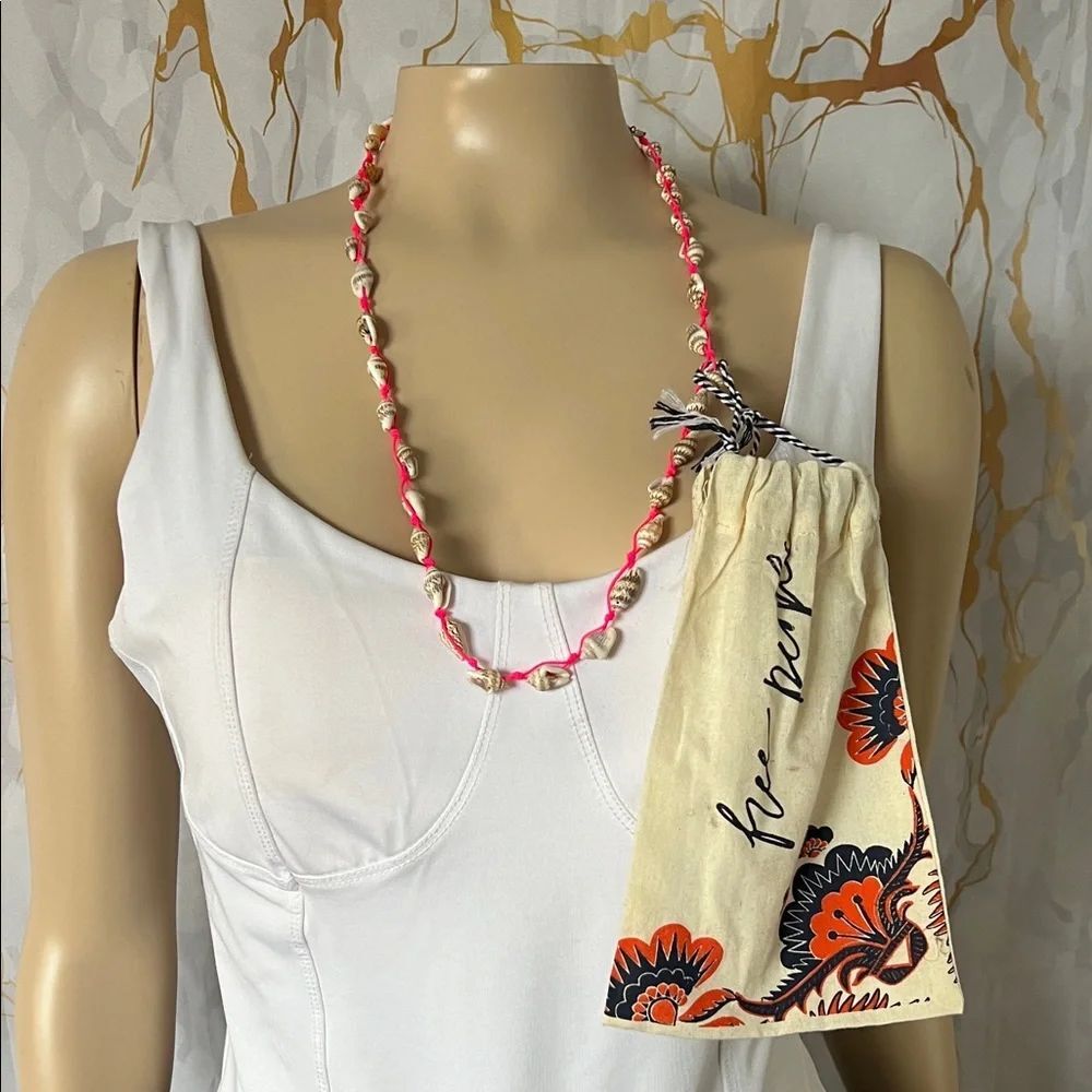 * Free People cowrie shell necklace with bright pink cord